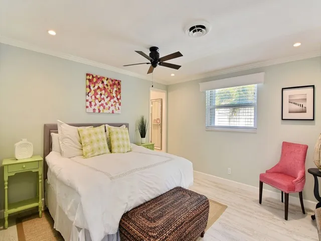 a bedroom with a bed and a chair