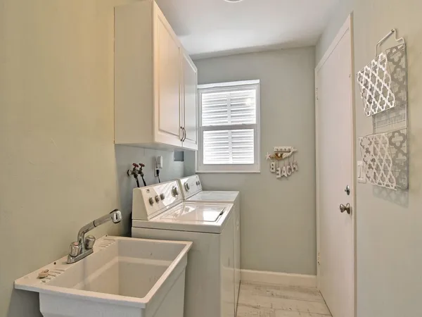 a bathroom with a sink a toilet and a window