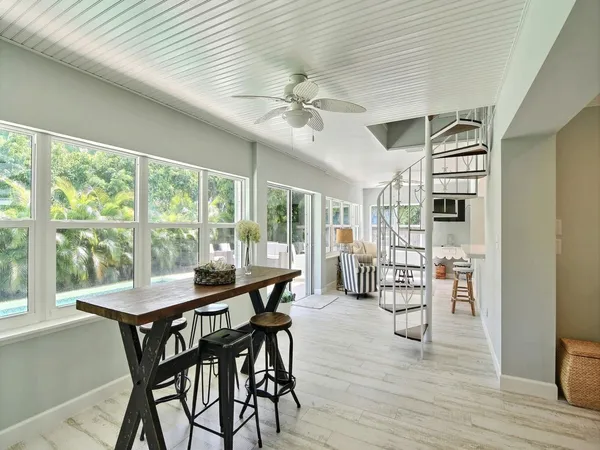 a view of a dining room with furniture window and wooden floor