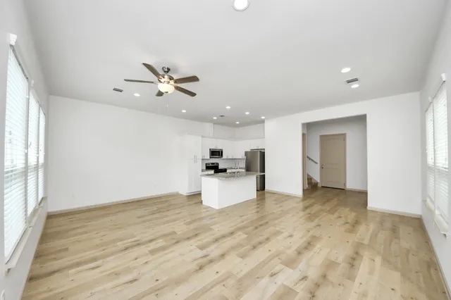 a view of a kitchen with a sink and a window
