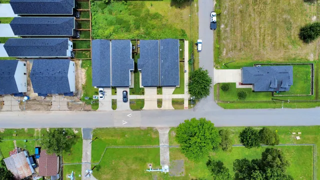 an aerial view of a house with a yard basket ball court and outdoor seating