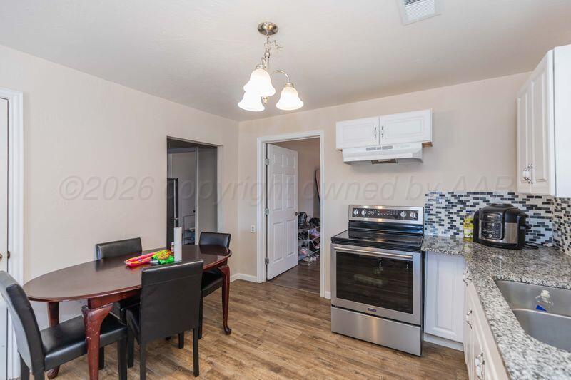 2106 Southwest 1st Avenue Amarillo, TX 79106 - Photo 3 of 17 a kitchen with stainless steel appliances a stove a table and chairs