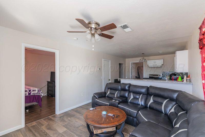 2106 Southwest 1st Avenue Amarillo, TX 79106 - Photo 5 of 17 a living room with furniture and a wooden floor
