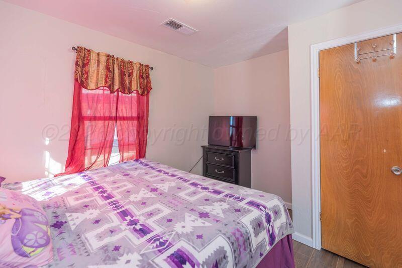 2106 Southwest 1st Avenue Amarillo, TX 79106 - Photo 7 of 17 a bedroom with a bed and a flat screen tv