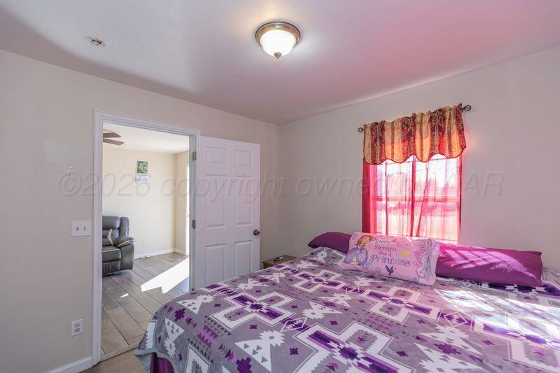 2106 Southwest 1st Avenue Amarillo, TX 79106 - Photo 8 of 17 a bedroom with a bed and a window