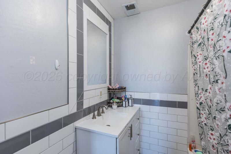 2106 Southwest 1st Avenue Amarillo, TX 79106 - Photo 9 of 17 a bathroom with a sink and a mirror