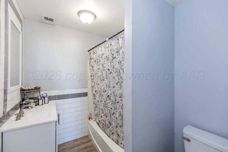 2106 Southwest 1st Avenue Amarillo, TX 79106 - Photo 10 of 17 a bathroom with a sink toilet and shower