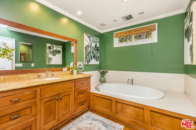 a bathroom with a sink a mirror and a bathtub