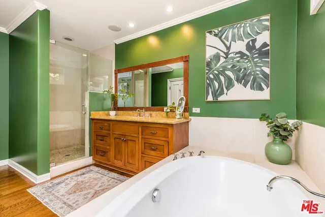 a bathroom with a tub sink and mirror