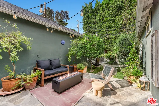 a backyard of a house with outdoor seating