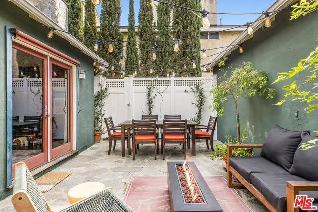 a view of a patio with a table and chairs