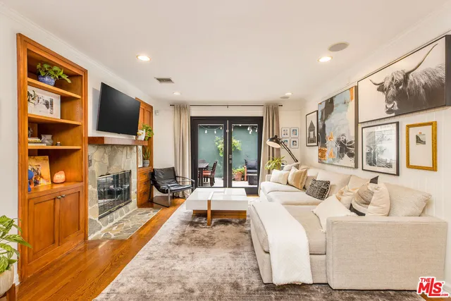 a living room with fireplace furniture and a flat screen tv
