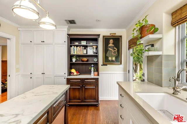 a kitchen with a sink appliances and cabinets