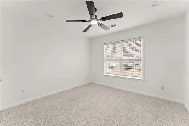 an empty room with ceiling fan