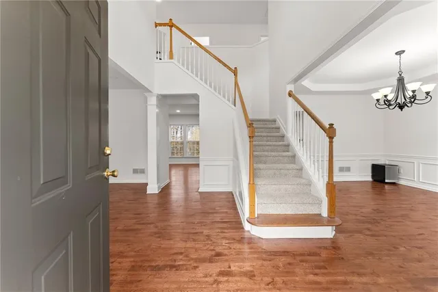 a view of entryway and hall with wooden floor