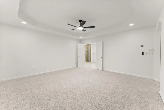 a large white kitchen with a sink and dishwasher with a large window