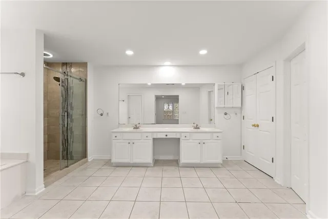 a large white kitchen with a sink