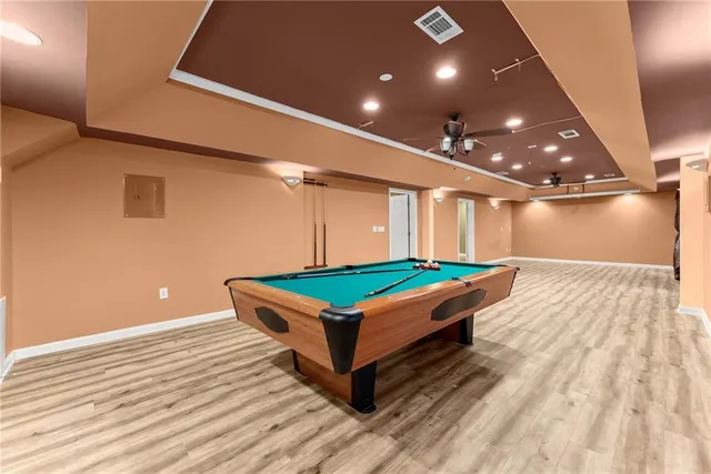 a view of a room with wooden floor and fan