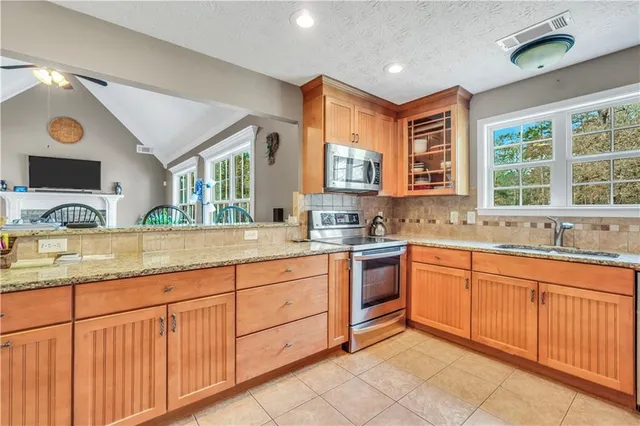 a kitchen with granite countertop a refrigerator and a sink