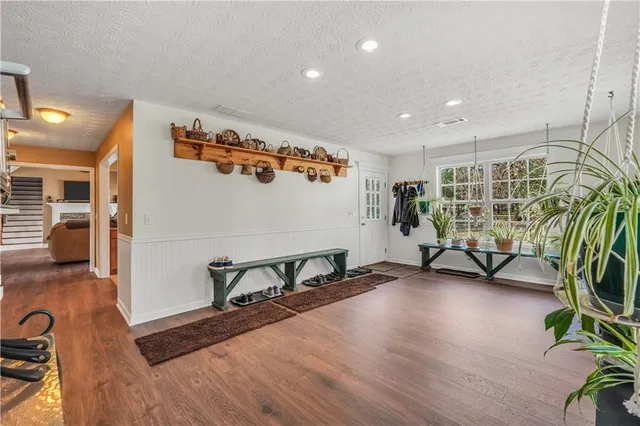 a view of a livingroom with wooden floor and a flat screen tv