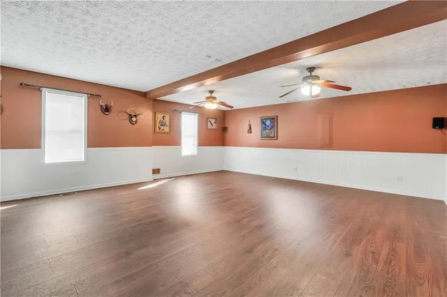 a bathroom with a granite countertop toilet sink and mirror