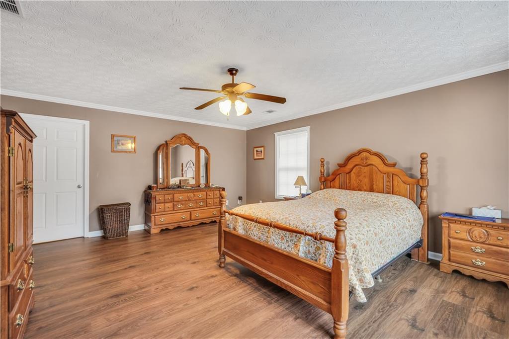 165 Riverbrooke Terrace Covington, GA 30016 - Photo 22 of 54 a bedroom with a bed and a chandelier