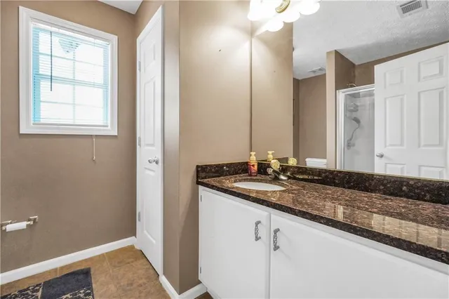 a bathroom with a toilet and shower