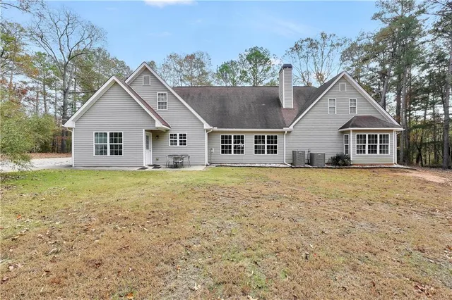 a house with large trees in front of it
