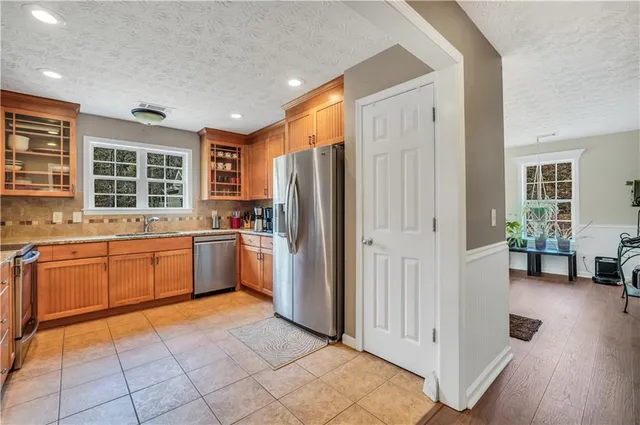 a bathroom with a granite countertop sink and a large mirror