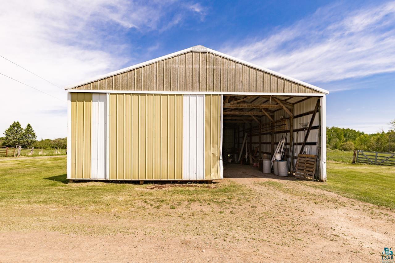 6606 Metso Road Kettle River, MN 55757 - Photo 68 of 84 Metal-sided barn featuring a peaked roof and open-front access