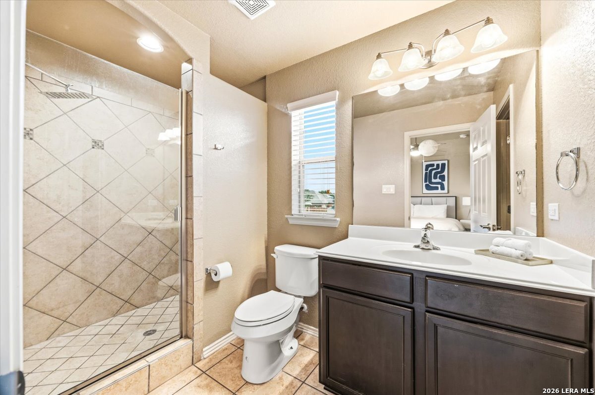 3831 Bacall Way Converse, TX 78109 - Photo 21 of 33 a bathroom with a sink a toilet and shower