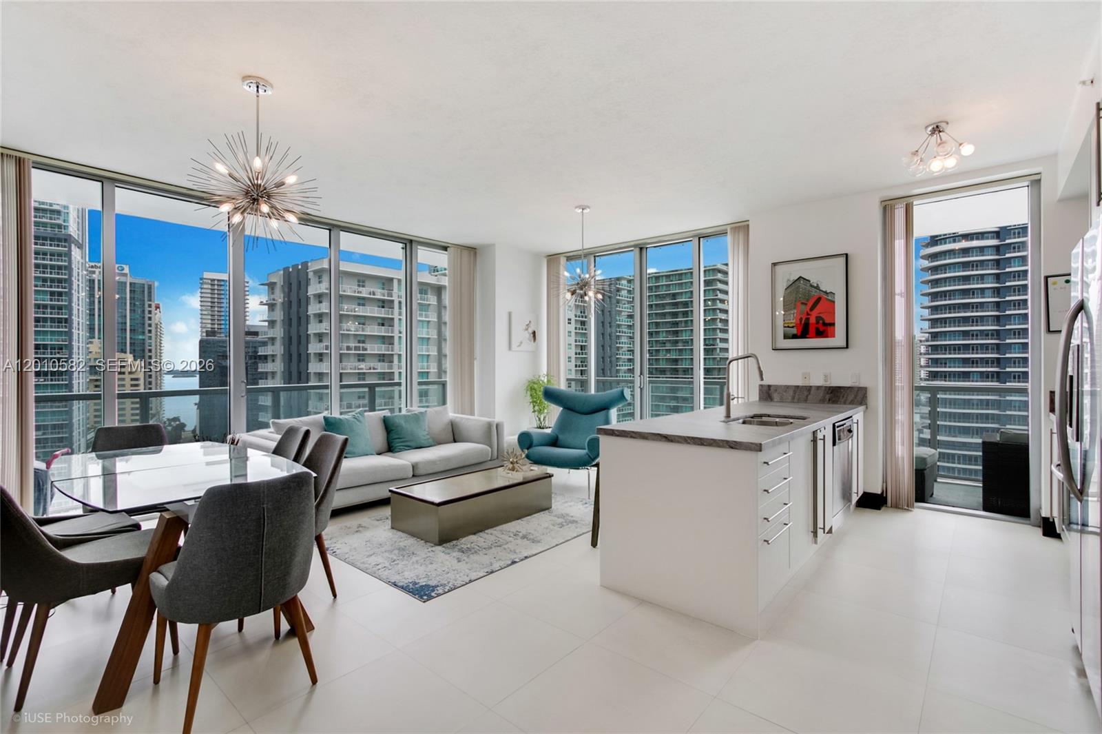 79 Southwest 12th Street, Unit 2306S Miami, FL 33130 - Photo 7 of 38 a living room with furniture and a chandelier