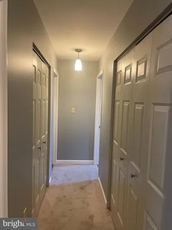 an empty room with a window and a ceiling fan