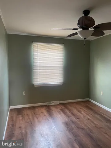 an empty room with wooden floor