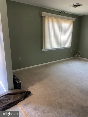 a view of an empty room with windows