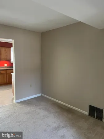 a view of an empty room and a window