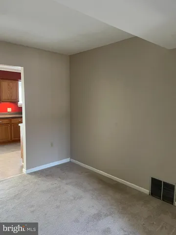 a view of an empty room and a window