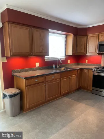a kitchen with a sink stove and cabinets