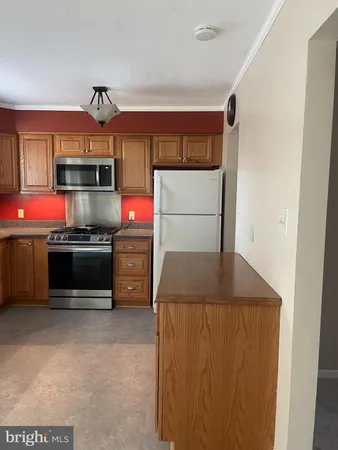 a kitchen with stainless steel appliances a stove and a refrigerator