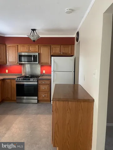 a kitchen with stainless steel appliances a stove and a refrigerator