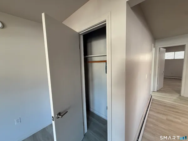 a view of hallway with wooden floor