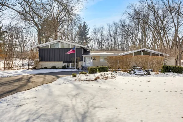 a view of a house with snow on the road