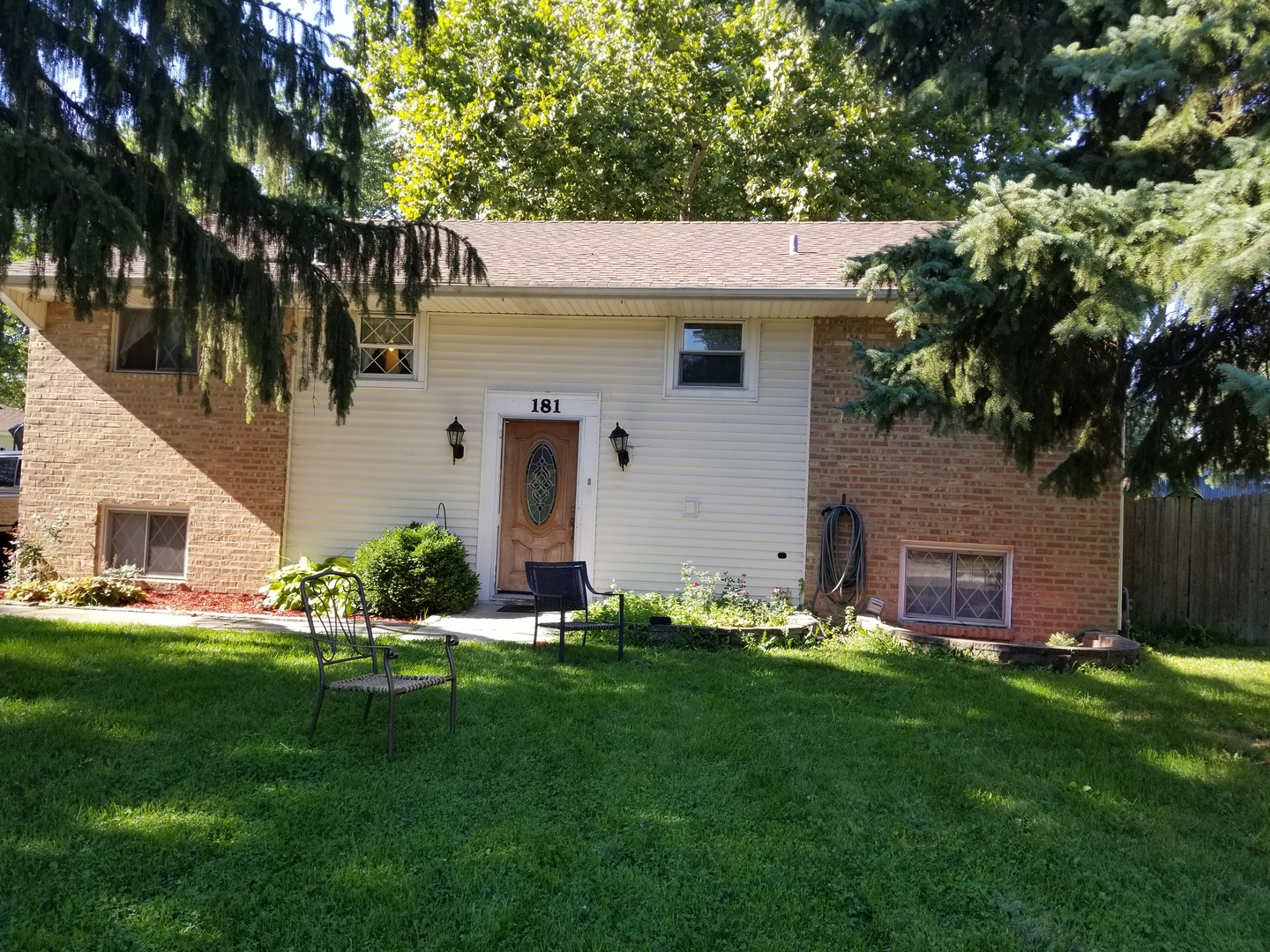 a front view of house with yard and green space