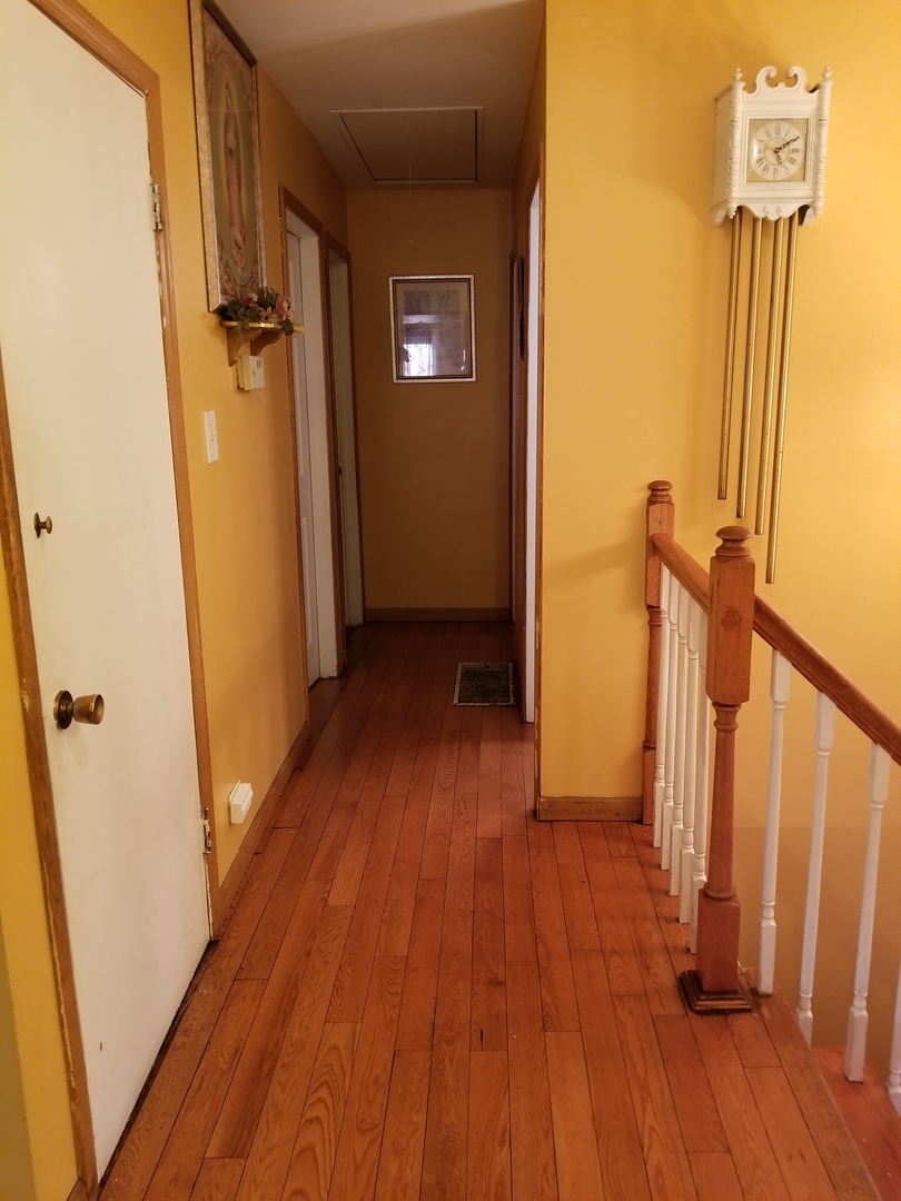 181 Oxford Road Bolingbrook, IL 60440 - Photo 12 of 29 a view of a hallway with wooden floor and staircase