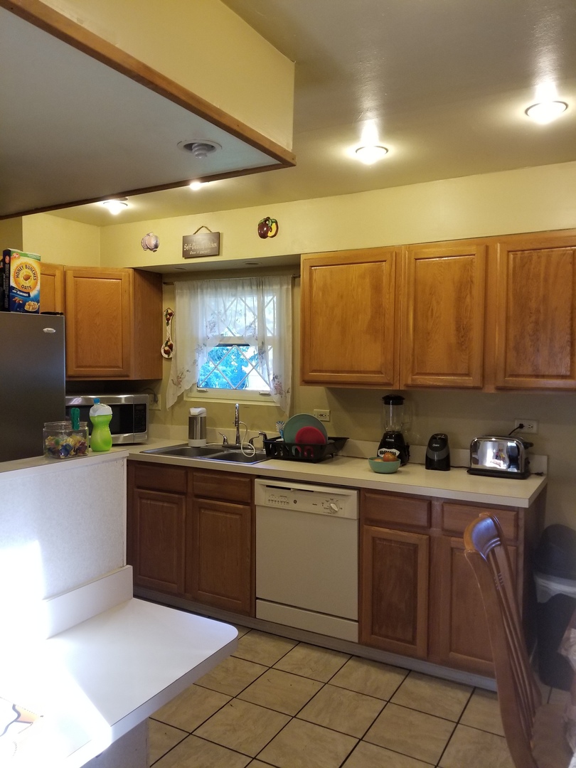 181 Oxford Road Bolingbrook, IL 60440 - Photo 24 of 29 a kitchen with a sink and cabinets