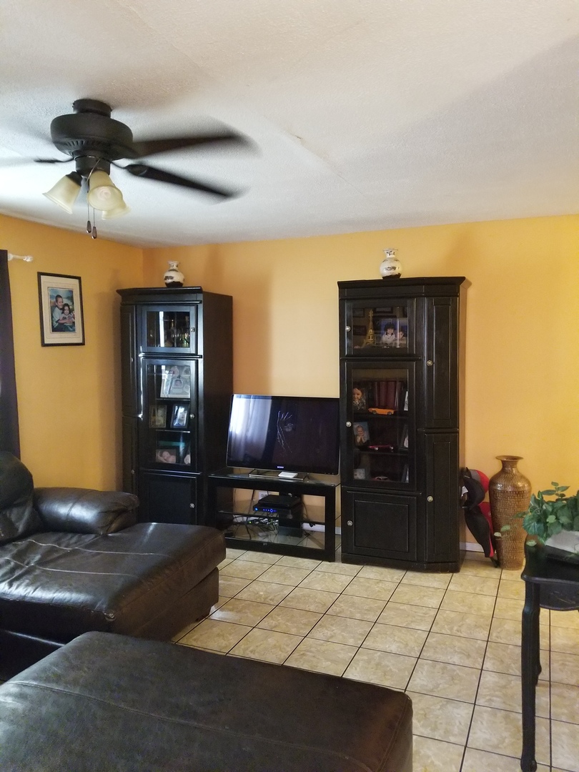 181 Oxford Road Bolingbrook, IL 60440 - Photo 8 of 29 a living room with furniture and a flat screen tv