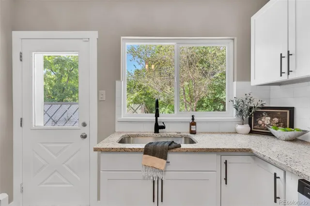a kitchen with a sink and large window