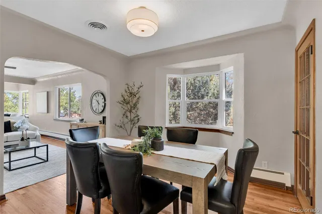 a view of a dining room with furniture window and wooden floor