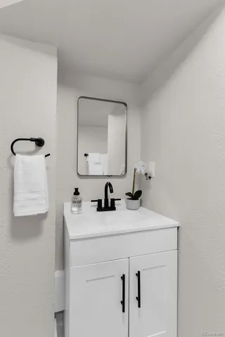 a bathroom with a sink vanity and mirror