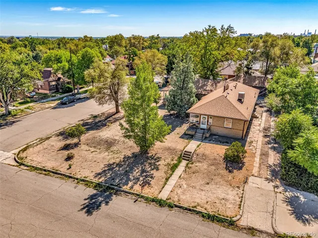 an aerial view of a house with a yard and lake view